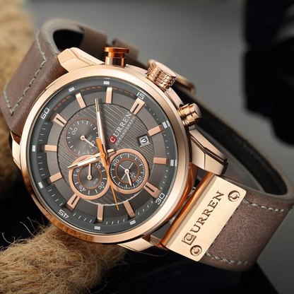 Rose Gold trim and brown cowhide leather strap, laying on its side