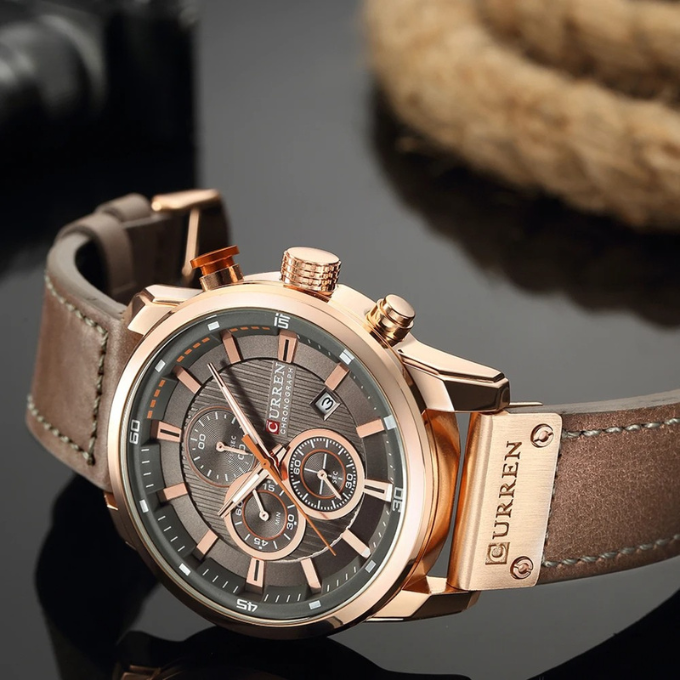 Rose Gold trim and brown cowhide leather strap, on its side